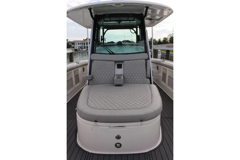 Slide: The Image of 2020 Boston Whaler 350 Outrage boat interior with cushioned seating and sleek design. - 12