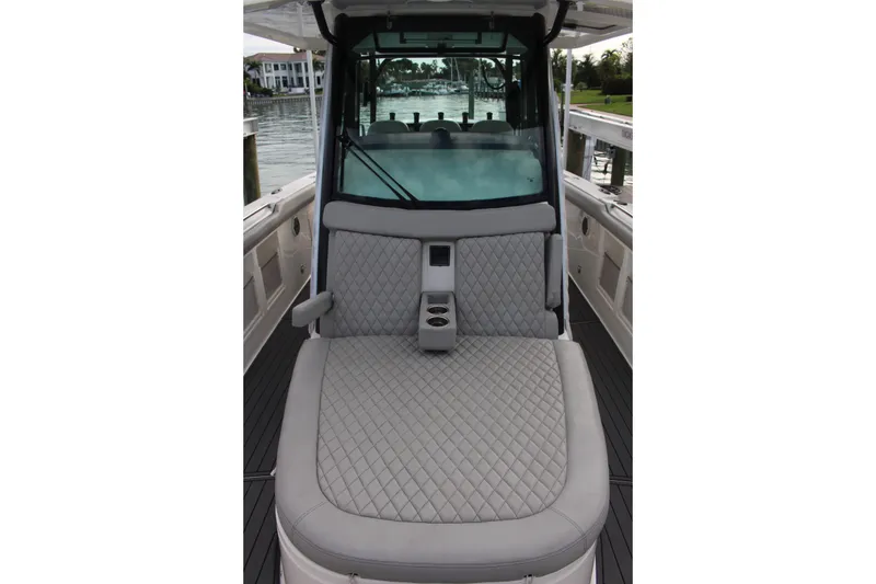 Slide: The Image of 2020 Boston Whaler 350 Outrage boat interior with quilted seating and cup holders. - 13