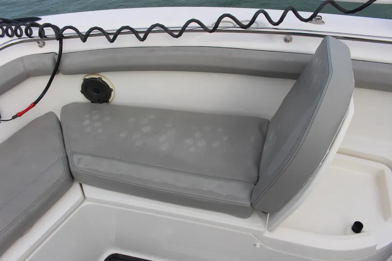 Slide: The Image of Boston Whaler 350 Outrage 2020 boat seating with gray cushions and speaker. - 17