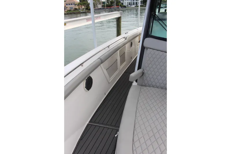 Slide: The Image of 2020 Boston Whaler 350 Outrage interior with quilted seating and sleek deck design. - 20