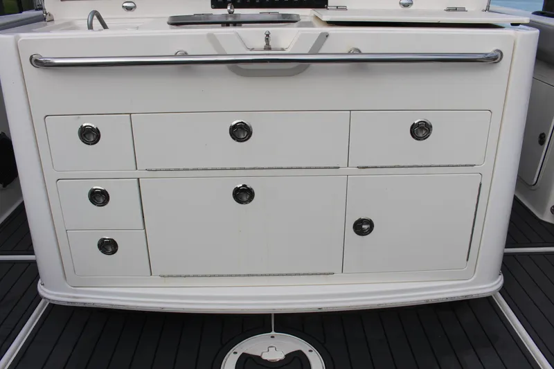 Slide: The Image of Boston Whaler 350 Outrage 2020 boat storage drawers and sink area. - 23
