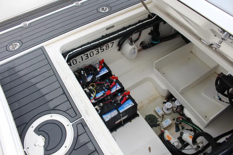 Slide: The Image of 2020 Boston Whaler 350 Outrage battery compartment with wiring and components. - 24