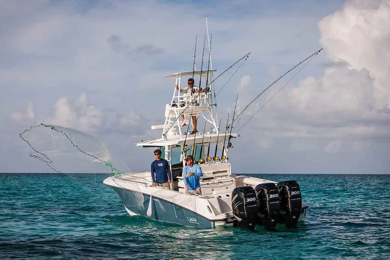 Slide: The Image of Manufacturer Provided Image: 2020 Boston Whaler 350 Outrage fishing boat with triple engines on open water. - 28