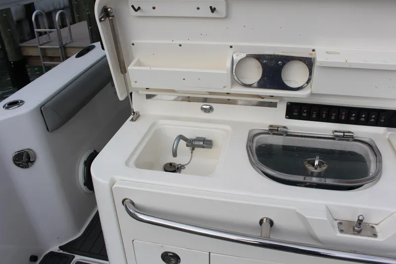 Slide: The Image of 2020 Boston Whaler 350 Outrage boat sink and storage area. - 3