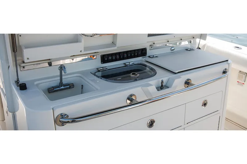Slide: The Image of Manufacturer Provided Image: Boston Whaler 350 Outrage 2020 boat galley with sink and storage. - 4