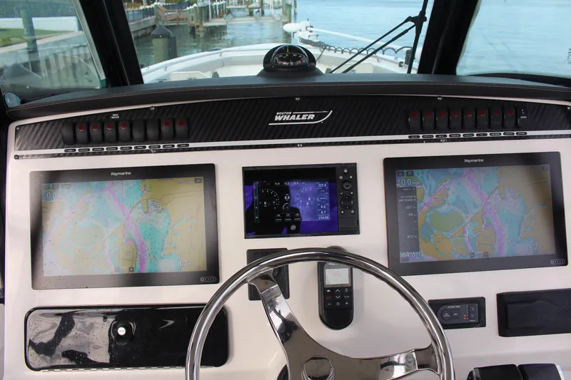 Slide: The Image of Control panel of 2020 Boston Whaler 350 Outrage with navigation screens and steering wheel. - 9