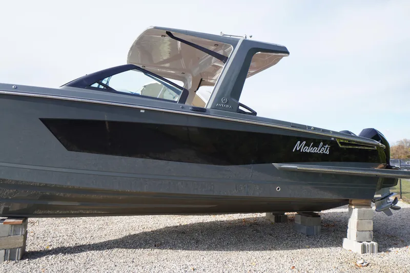 Slide: The Image of 2020 Aviara AV32 OB boat on blocks, side view, sleek design. - 1