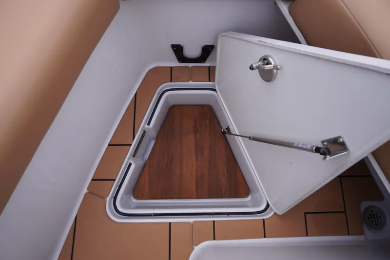 Slide: The Image of Storage compartment on 2020 Aviara AV32 OB boat with open hatch and wood flooring. - 13