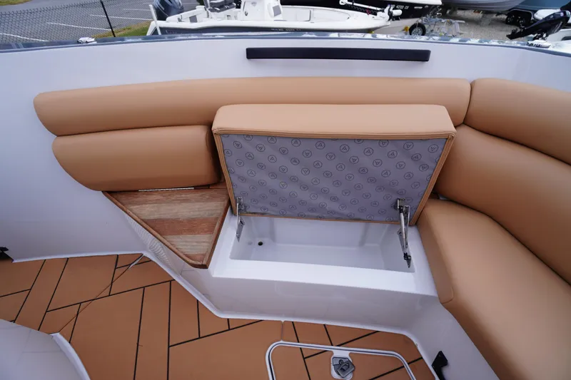 Slide: The Image of 2020 Aviara AV32 OB boat with tan seating and storage compartment open. - 17