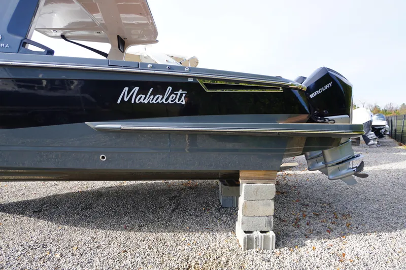 Slide: The Image of 2020 Aviara AV32 OB boat on blocks, featuring Mercury outboard engine. - 2