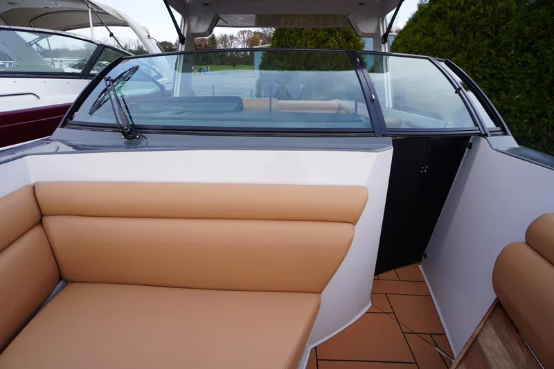 Slide: The Image of 2020 Aviara AV32 OB boat interior with tan seating and glass windshield. - 21