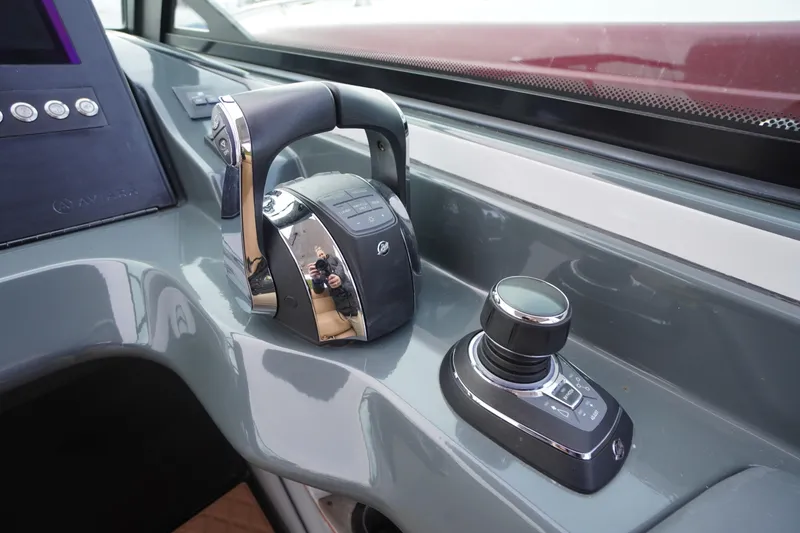 Slide: The Image of 2020 Aviara AV32 OB helm controls with joystick and throttle levers. - 28