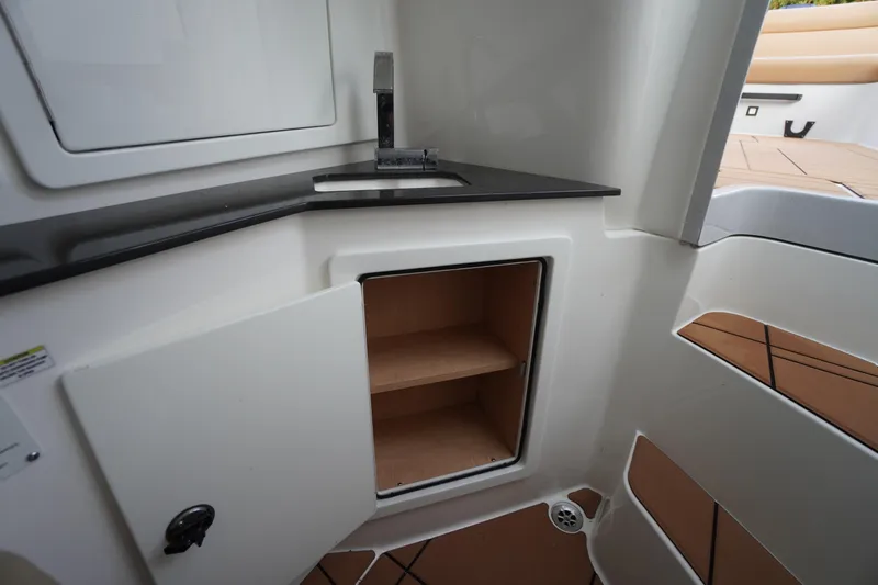 Slide: The Image of Interior of 2020 Aviara AV32 OB boat showing storage cabinet and sink area. - 36