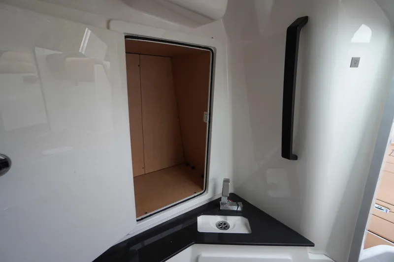 Slide: The Image of 2020 Aviara AV32 OB boat interior with sink and storage compartment. - 37