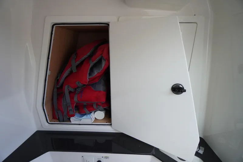 Slide: The Image of Storage compartment on 2020 Aviara AV32 OB boat with life jackets and supplies. - 38