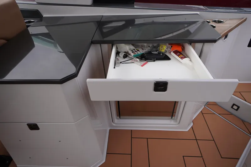 Slide: The Image of Open drawer in 2020 Aviara AV32 OB boat, containing various tools and items. - 45