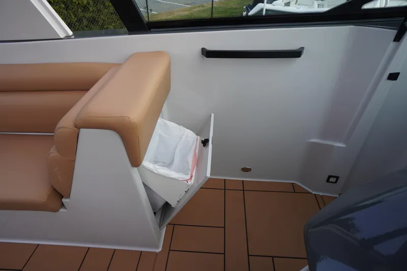 Slide: The Image of 2020 Aviara AV32 OB interior with tan seating and built-in storage compartment. - 47