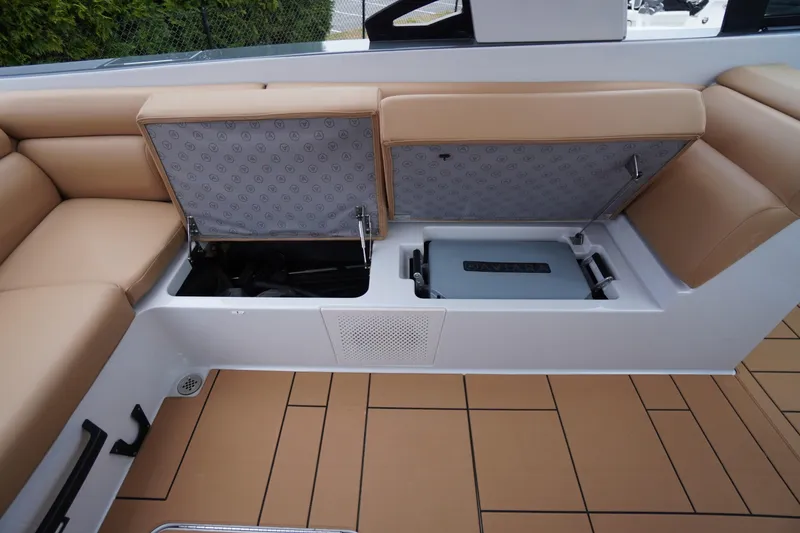 Slide: The Image of 2020 Aviara AV32 OB boat interior with open storage compartment and tan seating. - 53