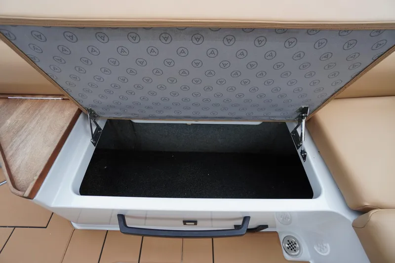 Slide: The Image of Open storage compartment in 2020 Aviara AV32 OB boat, featuring cushioned seating and wood accents. - 55