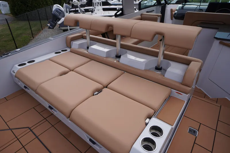 Slide: The Image of 2020 Aviara AV32 OB boat with tan seating and cup holders on deck. - 58