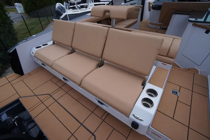 Slide: The Image of 2020 Aviara AV32 OB boat with tan seating and cup holders on deck. - 65