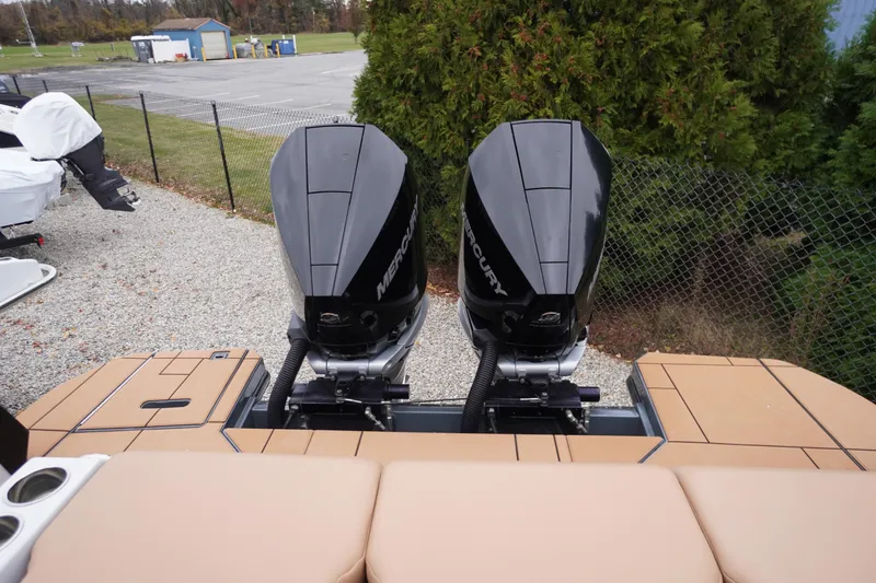 Slide: The Image of 2020 Aviara AV32 OB boat with dual Mercury outboard engines, parked outdoors. - 73