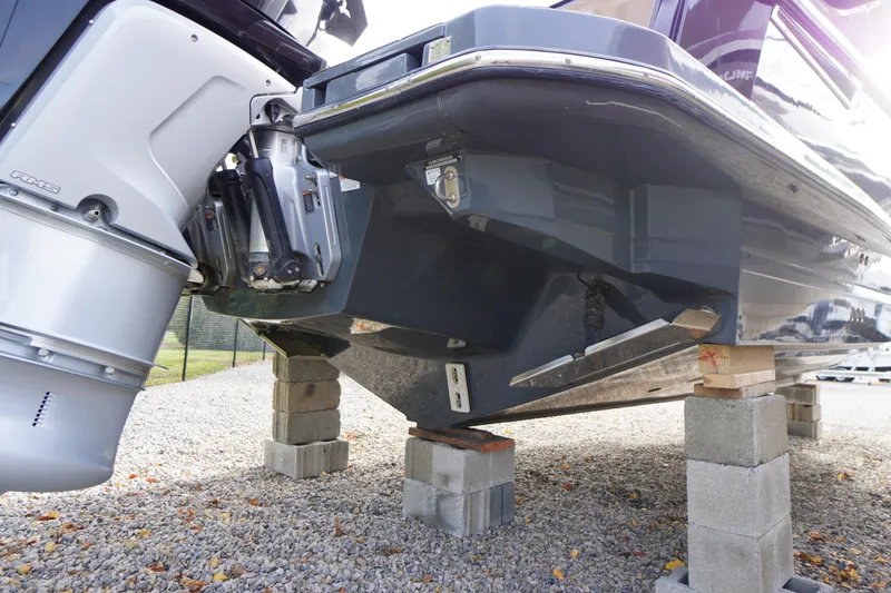 Slide: The Image of 2020 Aviara AV32 OB boat on blocks, showcasing outboard motor and hull design. - 79