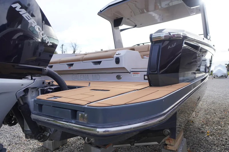 Slide: The Image of 2020 Aviara AV32 OB boat with Mercury engine, docked on gravel. - 80