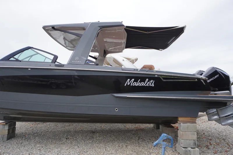 Slide: The Image of 2020 Aviara AV32 OB boat on blocks, featuring sleek design and Mercury engines. - 82