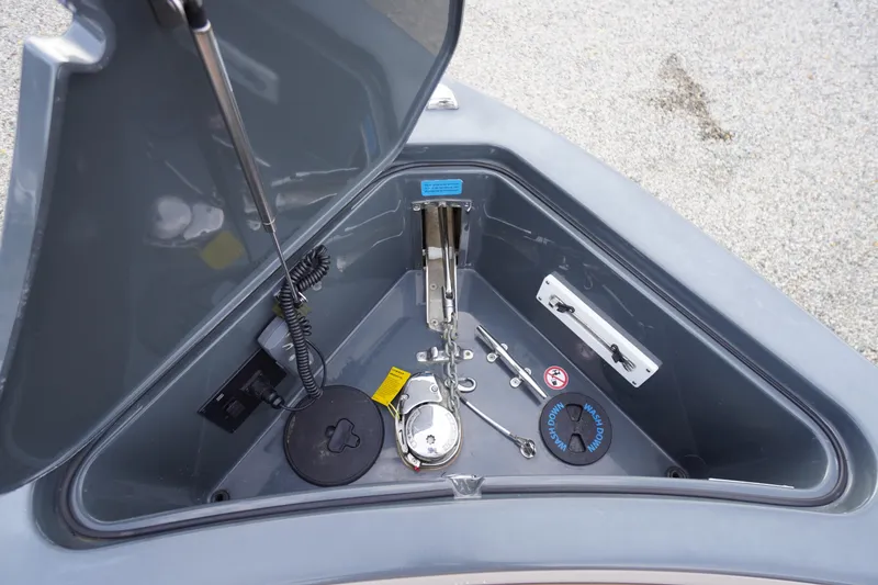 Slide: The Image of Anchor compartment of 2020 Aviara AV32 OB boat, featuring storage and control mechanisms. - 9