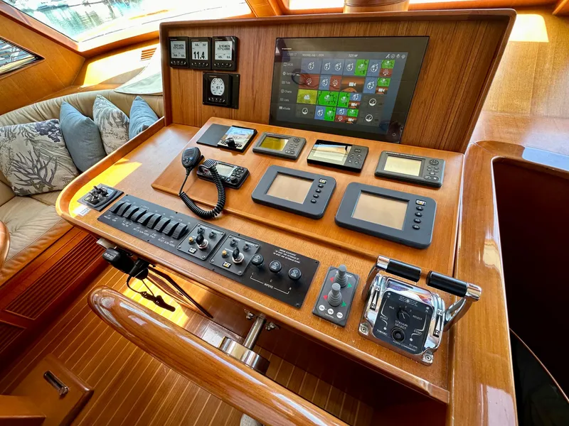 Slide: The Image of Control panel of 2005 Marlow Explorer 78 yacht with navigation instruments and wooden finish. - 15