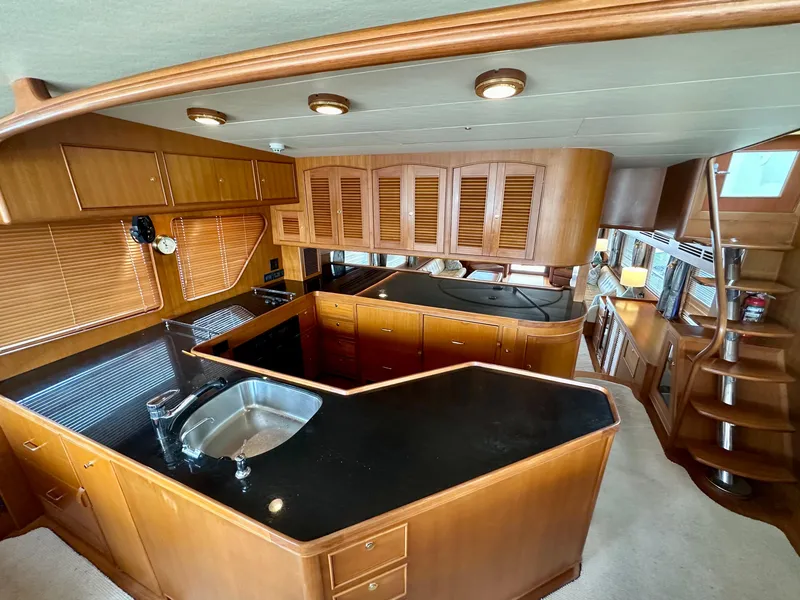 Slide: The Image of Luxurious kitchen interior of 2005 Marlow Explorer 78 yacht with wooden cabinetry and modern fixtures. - 16