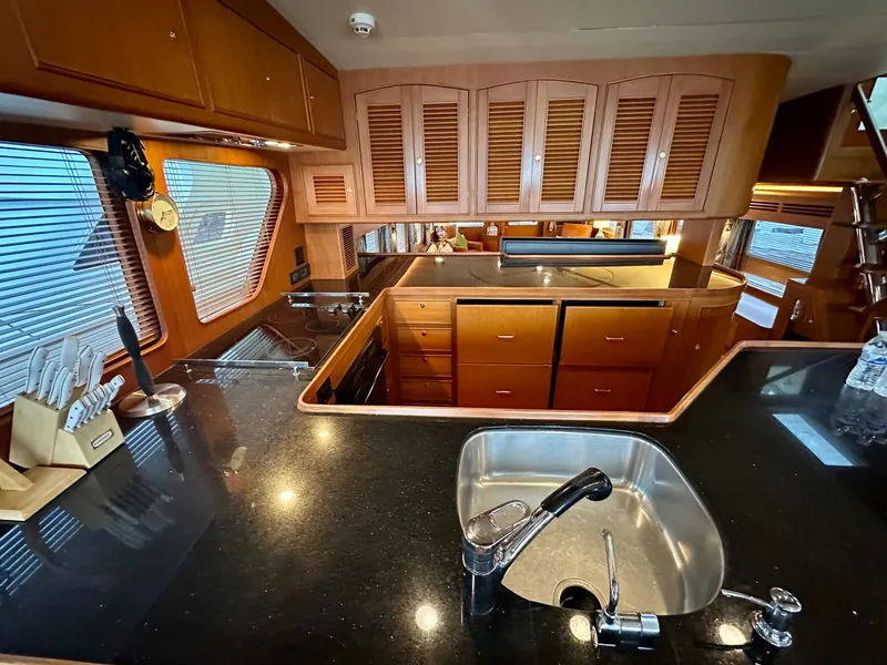 Slide: The Image of Luxurious kitchen interior of 2005 Marlow Explorer 78 yacht with wooden cabinets and modern amenities. - 17