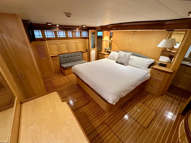 Slide: The Image of Luxurious bedroom in 2005 Marlow Explorer 78 yacht with wood accents and cozy seating. - 21