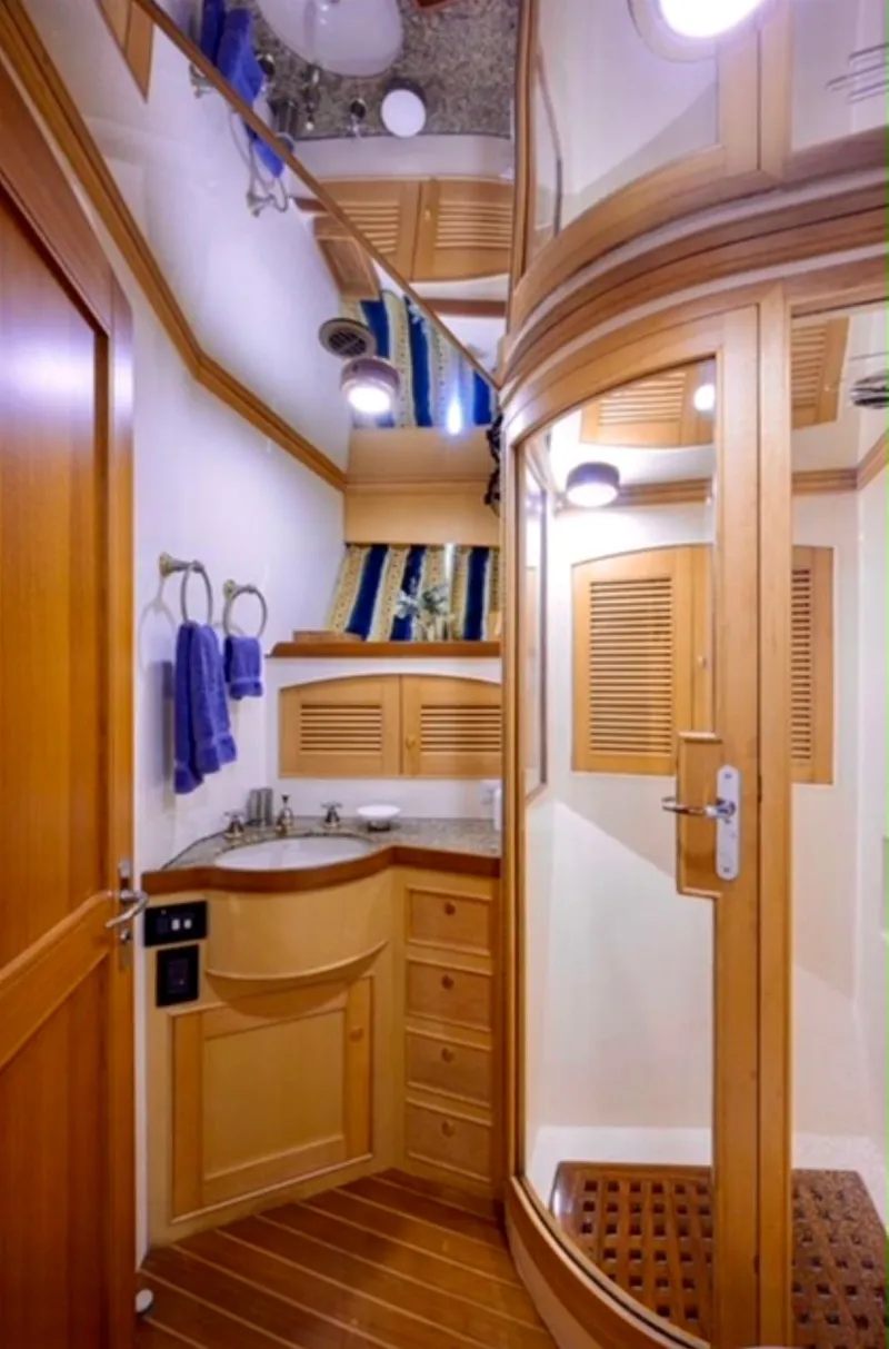 Slide: The Image of Luxurious bathroom in 2005 Marlow Explorer 78 yacht with wooden cabinetry and modern fixtures. - 23