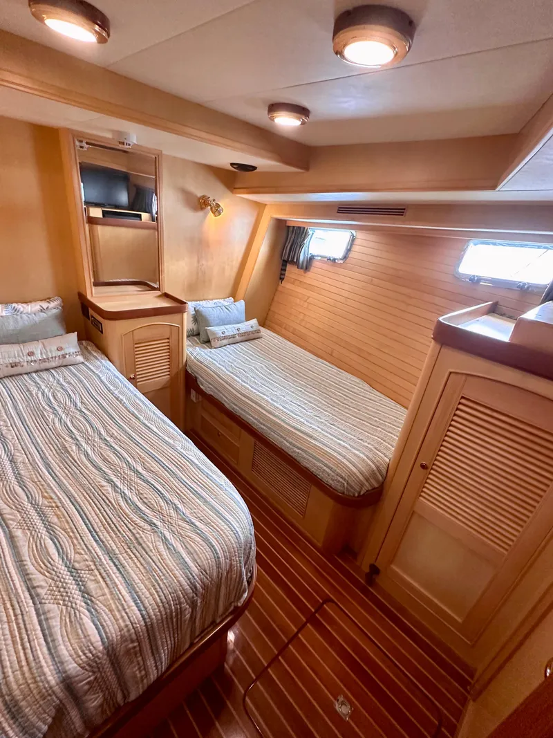Slide: The Image of Cozy cabin interior of 2005 Marlow Explorer 78 with twin beds and wooden accents. - 24