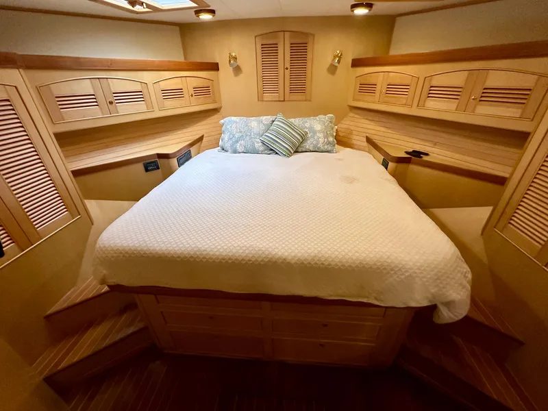 Slide: The Image of Luxurious bedroom in 2005 Marlow Explorer 78 yacht with wooden cabinetry and cozy bedding. - 26