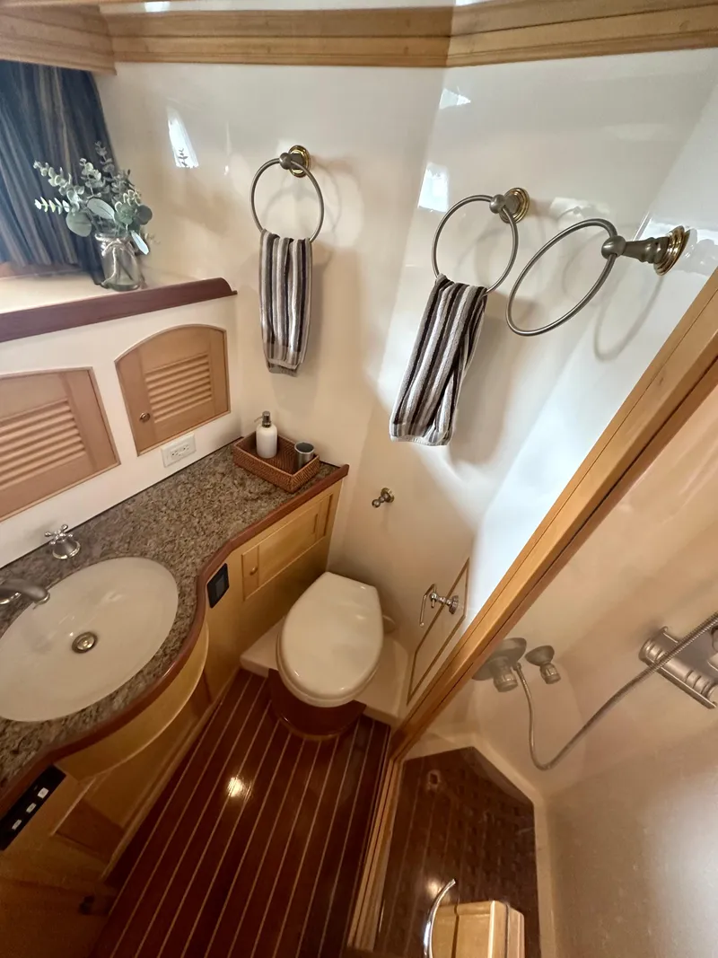 Slide: The Image of Luxurious bathroom in 2005 Marlow Explorer 78 yacht with elegant fixtures and wood accents. - 27