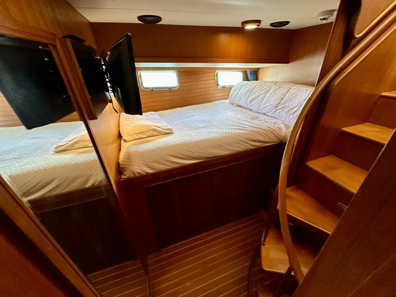 Slide: The Image of Luxurious cabin interior of 2005 Marlow Explorer 78 yacht with cozy bed and wooden stairs. - 28