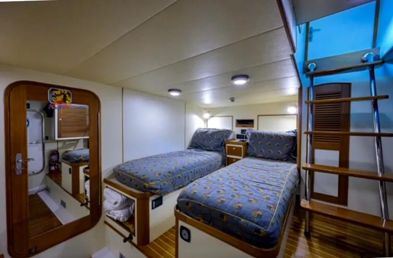 Slide: The Image of Twin beds in a cozy cabin of a 2005 Marlow Explorer 78 yacht. - 30