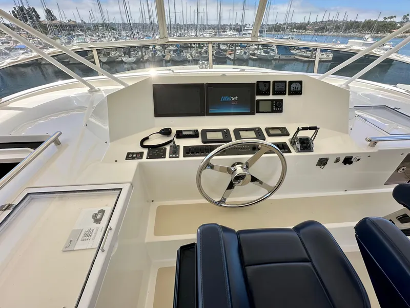 Slide: The Image of Helm of 2005 Marlow Explorer 78 yacht with navigation controls and steering wheel. - 32