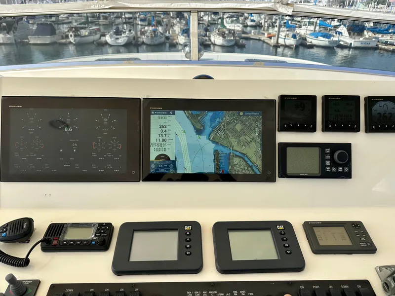 Slide: The Image of Control panel of a 2005 Marlow Explorer 78 yacht with navigation screens and instruments. - 33