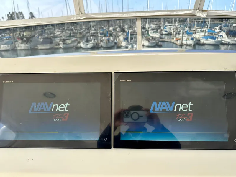 Slide: The Image of Dual NAVnet touch screens on a 2005 Marlow Explorer 78 yacht, with marina view. - 34