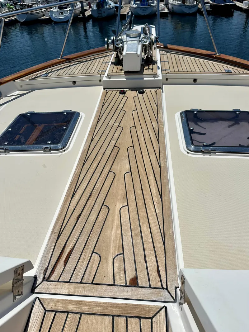 Slide: The Image of Deck view of 2005 Marlow Explorer 78 yacht with teak flooring and hatches. - 36