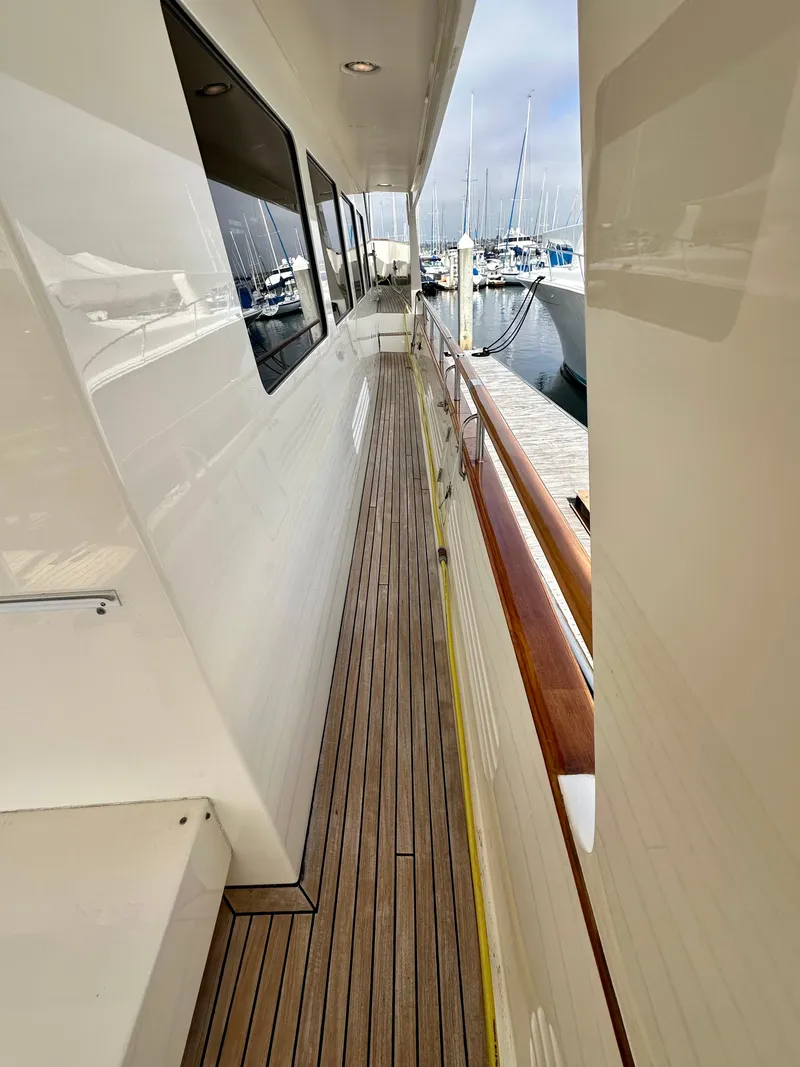 Slide: The Image of Side deck of 2005 Marlow Explorer 78 yacht with wooden flooring, docked at marina. - 38
