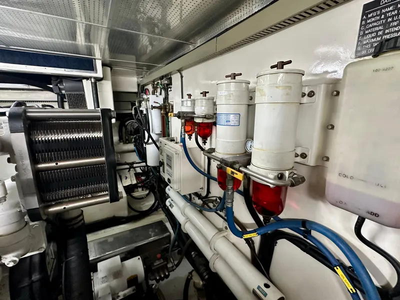 Slide: The Image of Engine room of 2005 Marlow Explorer 78 yacht, showcasing fuel filters and machinery. - 40