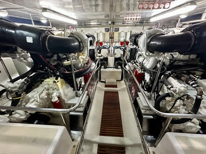 Slide: The Image of Engine room of a 2005 Marlow 78E yacht, showcasing dual engines and mechanical systems. - 47
