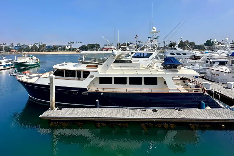 Slide: The Image of Luxury Marlow 78E yacht docked at marina, 2005 model, clear blue sky. - 49