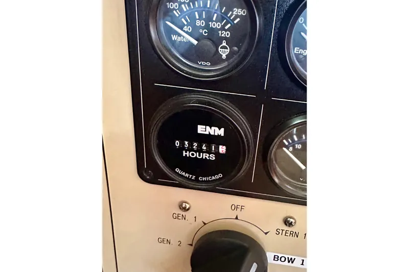 Slide: The Image of Instrument panel of 2005 Marlow 78E yacht showing engine hours and gauges. - 52