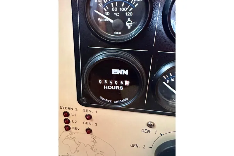 Slide: The Image of Instrument panel of 2005 Marlow 78E yacht showing engine hours and gauges. - 53